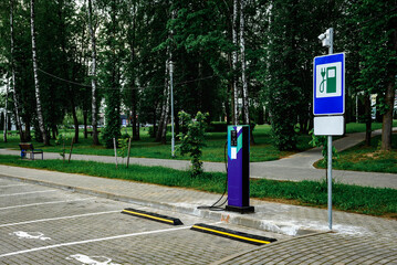 Power supply for charging of electric car on parking lot. Electric car charging station.