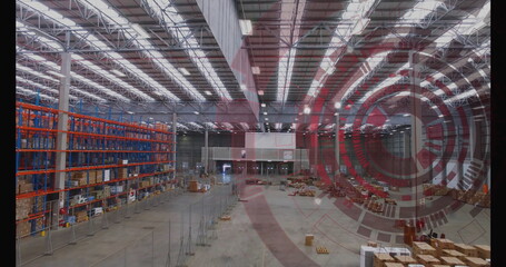 Showing warehouse interior featuring steel-truss roof under fluorescent lights, with pallet racks