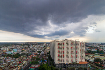 Saigon, Vietnam - 29 Apr, 2025 - A high-angle view of a modern cityscape beneath a dramatic sky...