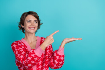 Photo portrait of pretty young girl point look hold empty space wear trendy red outfit isolated on...