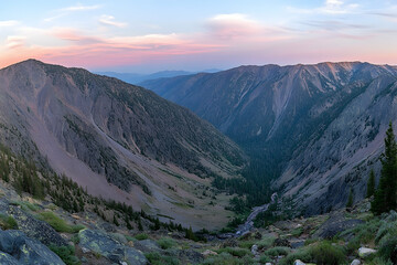 Dramatic Mountain Valley at Dusk with Pink Sky and Winding River