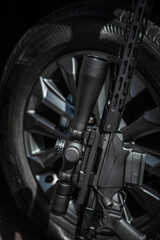 Fototapeta premium Sniper Rifle with Scope Against Car Wheel