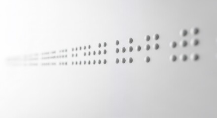 Close up view of braille text. Concept of accessibility and inclusivity for people with visual impairment. Sensory learning surface for education.