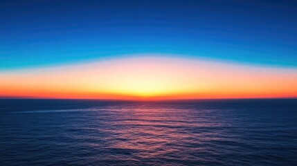 Obraz premium An ocean sunset bathes the sea in vibrant hues, with a horizon ablaze in orange, red, and yellow while transitioning to serene blue tones above, creating a tranquil seascape.