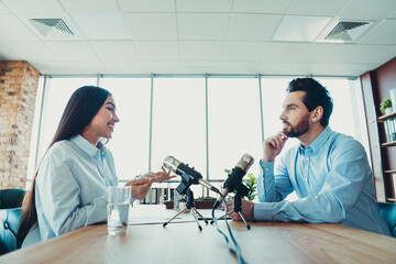 Professional colleagues collaborating in a modern office setting during an interview or coworking...