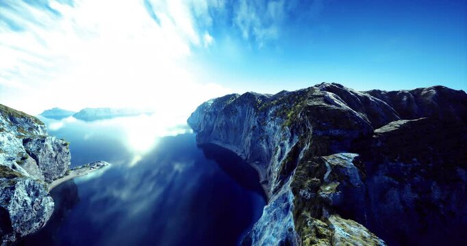 Spectacular landscape featuring stunning cliffs alongside calm waters under a clear blue sky. The sun reflects beautifully on the waters surface, creating a tranquil atmosphere.