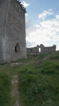 Ancient stone fortress with tower under cloudy sky