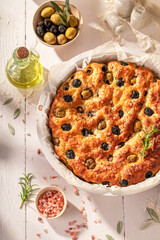 Hot focaccia baked in round baking tin.