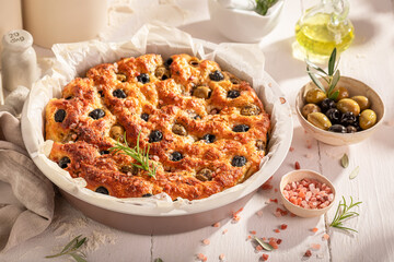 Hot focaccia with green and black olives.