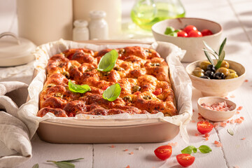 Homemade focaccia with green olives and cherry tomatoes.