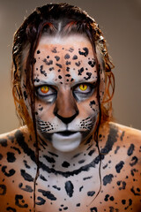 Woman with realistic artistic jaguar makeup, intense yellow eyes, detailed body paint and intense...