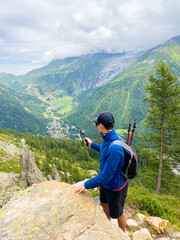 Capturing the Alpine View: A Hiker’s Pause Above the Valley. Vertical
