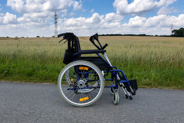 Peace and landscape: wheelchair in front of a grain field