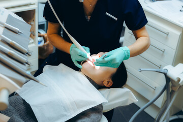 Dentist treats teeth to patient in home dentistry.