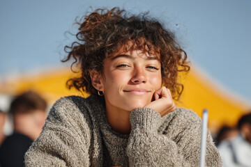 Teen girl smiling outdoors in bright sunlight