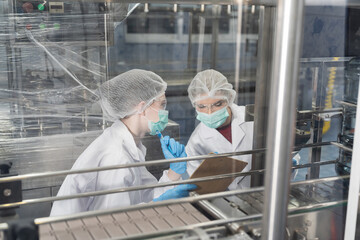 Drinking water manufacturers. Water filling machine. 20 Liter bottled on conveyor during filling...