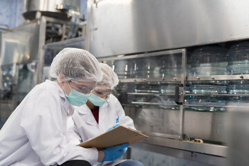 Drinking water manufacturers. Water filling machine. 20 Liter bottled on conveyor during filling...