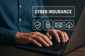 Person typing on a laptop with cyber insurance icons displayed above the keyboard on the screen area
