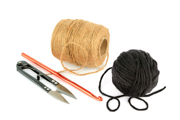 Balls of yarn, scissors and crochet hook isolated on white background.