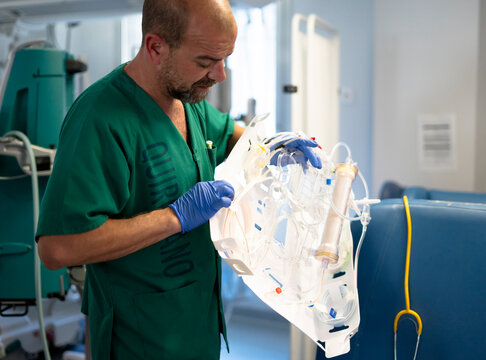 Surgeon preparing ecmo machine for lung support in hospital operating room