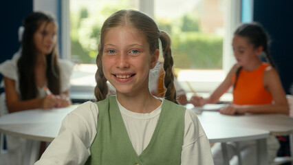 Caucasian girl portrait happy schoolgirl pupil student learner in classroom primary school...