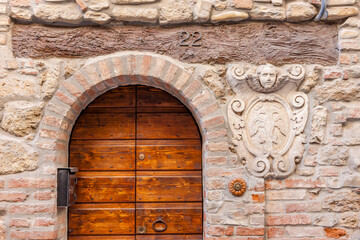 Rustic Wooden Door with Stone Archway and Carved Details