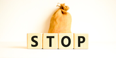 Stop symbol. Concept word Stop on beautiful wooden blocks. Beautiful canvas bag. Beautiful white...