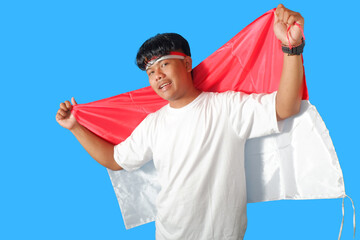 Proud Man Holding Indonesian Flag, Patriotic Celebration isolated on blue background