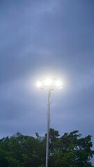 Streetlight glowing through cloudy evening