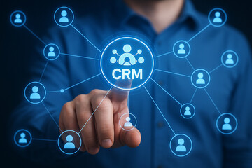 A man touching a crm icon surrounded by user icons connected by lines on a blue background shirt