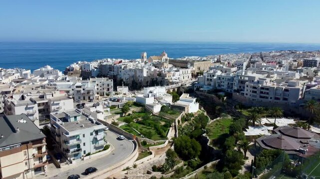 Drone footage of Polignano a Mare, Italy &ndash; featuring Lama Monachile beach, turquoise sea, dramatic cliffs, and scenic views of the Adriatic coastline in Puglia.