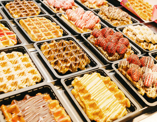 Filled Belgian waffles on display in a shop window.