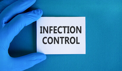 Infection control symbol. Concept words Infection control on beautiful white card. Doctor's hand in...