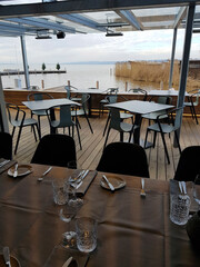 Modern restaurant overlooking Lake Neusiedl, set tables waiting for customers in Burgenland, Austria