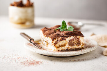Piece of traditional Italian dessert tiramisu on white background