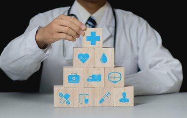 Businessman hand arranging wood block stacking with the healthcare medical icon. Health insurance  health concept