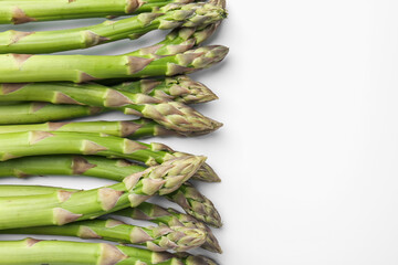 Fresh ripe raw asparagus on white background, flat lay