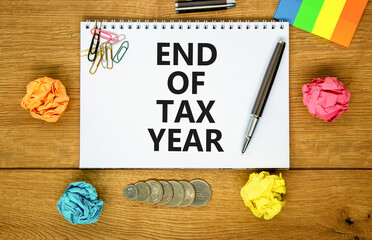 End of tax year symbol. Concept words phrase End of tax year on beautiful white note. Colored...
