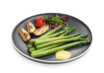 Tasty cooked asparagus with baked potatoes, tomatoes and sauce isolated on white