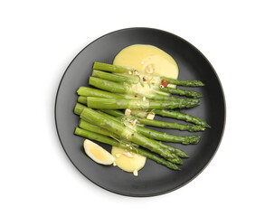Tasty cooked asparagus with lemon and sauce isolated on white, top view