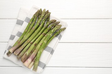 Fresh raw asparagus spears on white wooden table, top view. Space for text