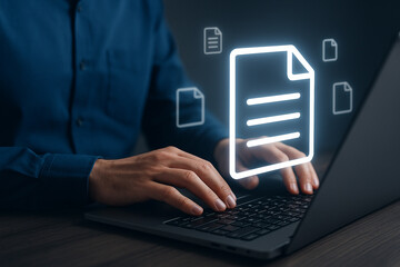 Person using laptop with document icons floating above the keyboard and hands in a dark setting