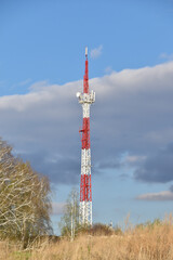 The communication tower is painted in red and white. A communications tower in rural areas.