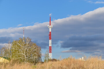 The communication tower is painted in red and white. A communications tower in rural areas.