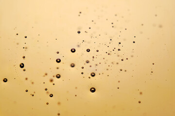 Golden background with oil and bubbles.