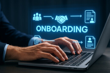 Man typing on laptop with onboarding graphic overlay showing team handshake and document icons in blue light