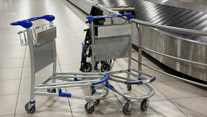 Luggage carts huddle conspiratorially by the silent carousel, echoing travel tales and wanderlust on International Civil Aviation Day