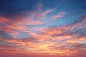 Obraz premium Dramatic Sky with Pink and Orange Cirrus Clouds against a Deep Blue Backdrop