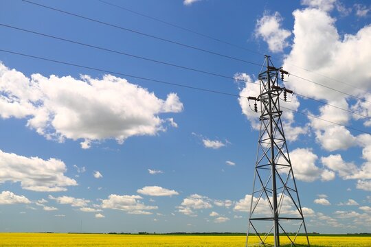 power line tower against blue sky - Powered by Adobe