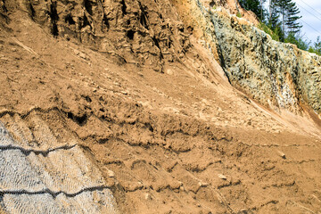 Rugged sediment layers cascade like ancient history's tapestry, revealing geologists' dreams and...